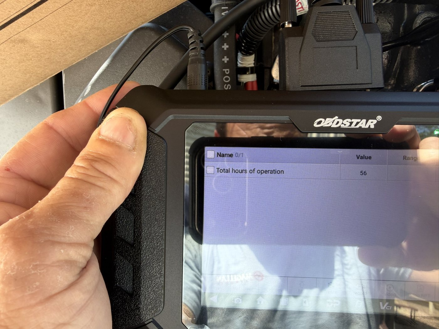 OBDSTAR diagnostic scanner showing 56 total hours of operation